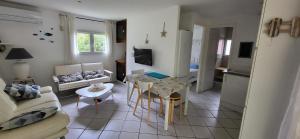 a living room with a couch and a table at Les Mayombes in Roquebrune-sur-Argens