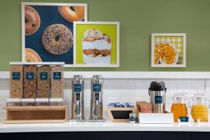 a counter with donuts and other food items on it at Spark by Hilton Edmundston in Edmundston