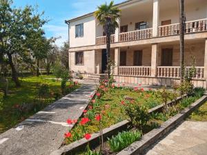 an old house with flowers in front of it at Guest house Gio in Kobuleti