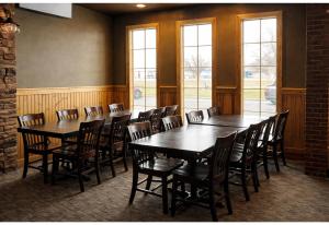 a row of tables and chairs in a room with windows at Studio 6 Suites Rawlins WY in Rawlins