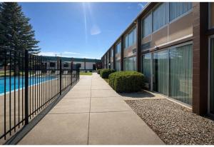 a walkway in front of a building with a pool at Studio 6 Suites Rawlins WY in Rawlins
