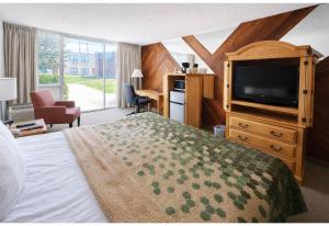 a hotel room with a bed and a television at Studio 6 Suites Rawlins WY in Rawlins