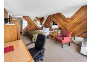 a bedroom with a bed and a desk and a chair at Studio 6 Suites Rawlins WY in Rawlins +24 photos