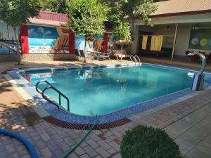 a large swimming pool with a hose in front of a building at Comfort Continent in Oktyabrʼ