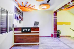 an office lobby with a door with a sign on it at Super HOTEL O UTSAV STAY in Jālahalli +23 photos