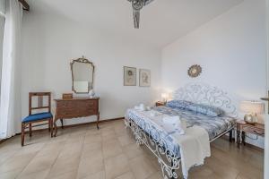 a bedroom with a bed and a dresser and a mirror at Classic Breeze - vista mare - terrazza - WiFi in Varazze