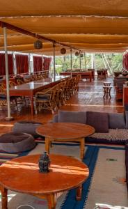 a room with tables and couches and tables and chairs at Dahabiya cruise in Luxor