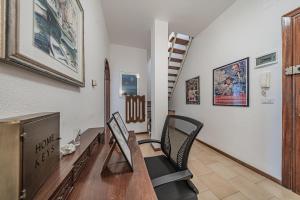 a home office with a desk and chairs and a tv at Classic Breeze - vista mare - terrazza - WiFi in Varazze