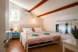 a bedroom with a bed and a table and a window at Studio Apartman Blue Sky in Senj