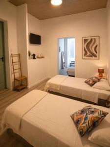a hotel room with two beds and a television at Maria's in Faro