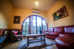 a living room with a red couch and a table at Castellu Rossu in Lucciana