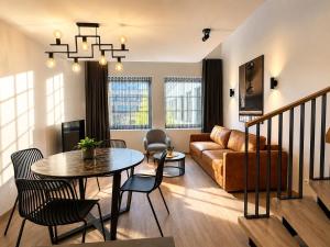 a living room with a table and a couch at Filosoofi Suites in Tartu