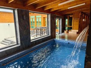 a swimming pool in a house with windows at اكواخ لاكجري ابها in Abha