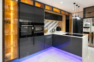 a kitchen with black cabinets and a purple floor at Kumnandi Guesthouse in Beacon Bay