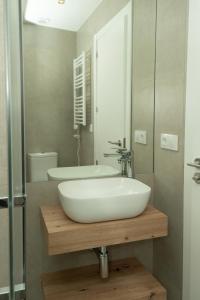 a bathroom with a white sink and a mirror at Carvajal Street, Private rooms in Madrid