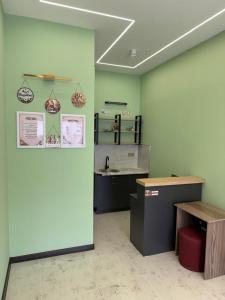 a green room with a counter and a desk at Eco Otel in Quba +11 photos