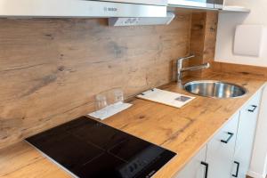 a kitchen counter top with a sink and a sink at Hotel Restaurant Fallerhof in Bad Krozingen +79 photos