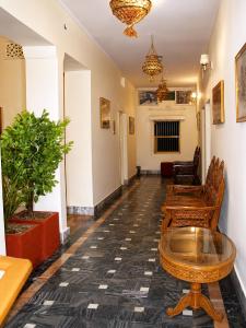 a hallway with a table and chairs in a room at Hotel Robin Jaisalmer Near fort view in Jaisalmer