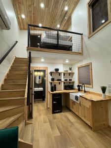 a room with a staircase and a loft at Tiny Cabin #2 at The Cedars in Kanab