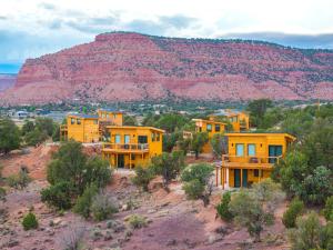 a group of yellow houses on a hill with a mountain at Tiny Cabin #1 at The Cedars in Kanab