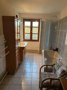 a bathroom with a tub and a sink at La Parenthèse in Bourg-Saint-Andéol +9 photos