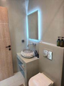 a bathroom with a sink and a mirror at Agapi's Nest in Agápi