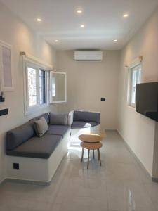 a living room with a couch and a table at Agapi's Nest in Agápi