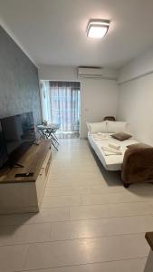 a bedroom with a bed and a television in it at Sab Luxury Apartments in Saturn