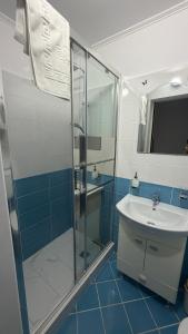 a bathroom with a glass shower and a sink at Sab Luxury Apartments in Saturn +8 photos