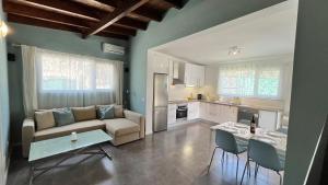 a living room with a couch and a table and a kitchen at Finca House by Fataga Maspalomas in San Bartolomé