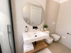 a bathroom with a white sink and a mirror at Casa Pelagos in Brindisi