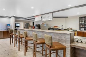 a row of stools at a bar in a restaurant at Best Western Denver East in Denver