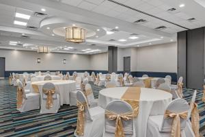 a banquet hall with white tables and chairs at Best Western Denver East in Denver +110 photos