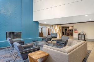 a lobby with couches and chairs and a fireplace at Best Western Denver East in Denver