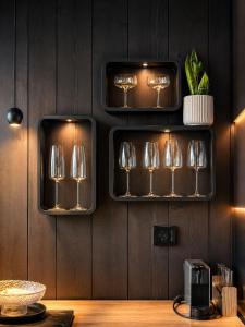 a row of wine glasses hanging on a wall at Nordik Crest in Mărişel