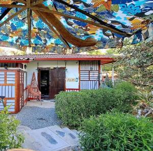 a small house with a colorful roof and a building at Casa Turística Art-Vélez Salento in Salento