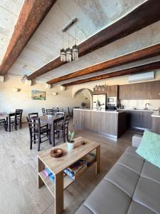 a living room and kitchen with a table and chairs at Soleil B&B Gozo in Għarb