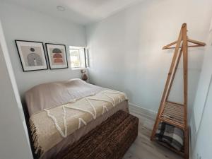 a bedroom with a ladder next to a bed at Casa Da Aldeia in Alcácer do Sal +3 photos