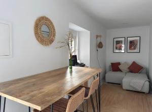 a dining table in a living room with a couch at Casa Da Aldeia in Alcácer do Sal