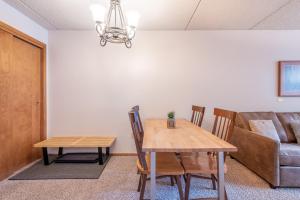 a dining room with a table and chairs and a couch at Village Square West 353 in Copper Mountain