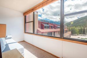 a room with a large window with a mountain view at Village Square West 353 in Copper Mountain
