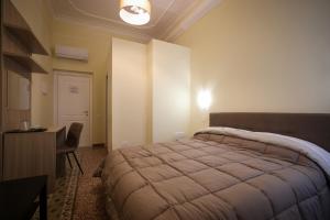 a bedroom with a bed and a table and a desk at B&B Salerno Stay in Salerno