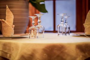 four empty wine glasses sitting on a table at Castellu Rossu in Lucciana