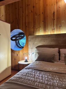 a bedroom with a bed and a wooden wall at Albergo Ristorante Lo Scoiattolo in Campigna