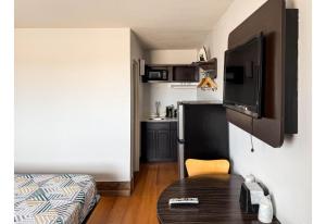 a living room with a table and a tv in a room at Studio 6 Pecos Texas in Pecos