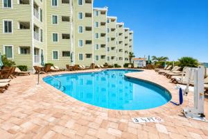 a swimming pool in front of a large apartment building at Sands Beach Club in Myrtle Beach