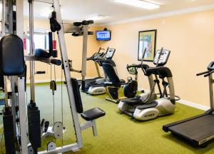 a gym with several treadmills and exercise bikes at Sands Beach Club in Myrtle Beach
