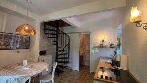 a kitchen and a dining room with a table and a kitchen and a room at Wienerwaldhof in Irenental