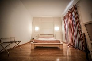 a bedroom with a bed in the middle of a room at Castellu Rossu in Lucciana