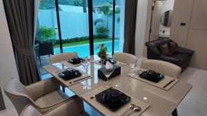 a dining room with a table and chairs at Zoha 2BR Private Pool Villa Bangtao in Thalang